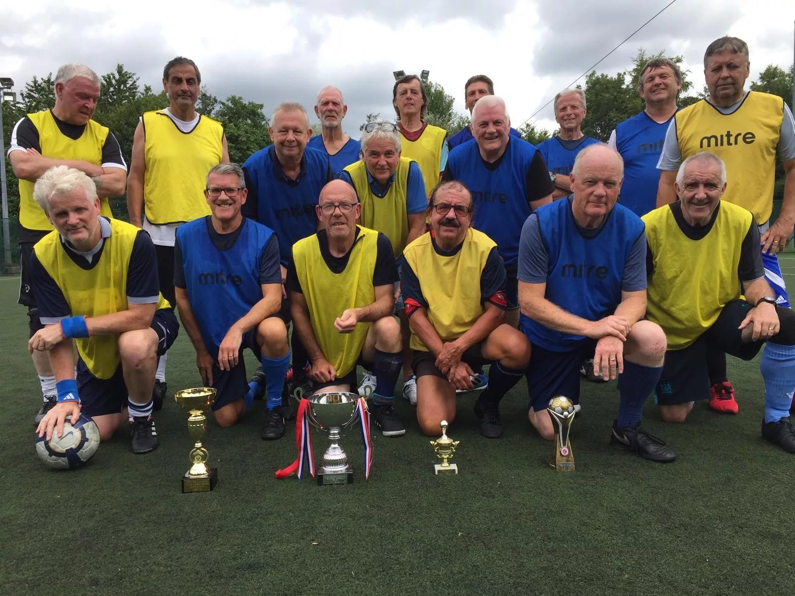 football team at Bolton Arena with trophy